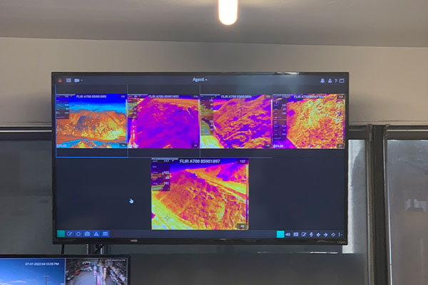 Fire detection system being displayed on a big monitor in control room. In the monitor display you see thermal images of thermal monitoring.