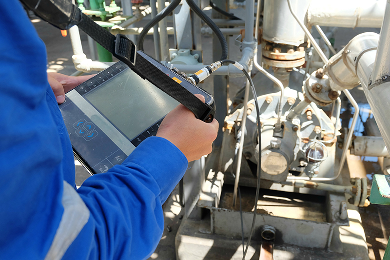 Mechanical engineer use vibration meter to measurement of centrifugal pump vibration and electric motor at oil and gas plant or chemical factory.